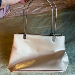 Soft champagne colored cocktail handbag with metal hardware